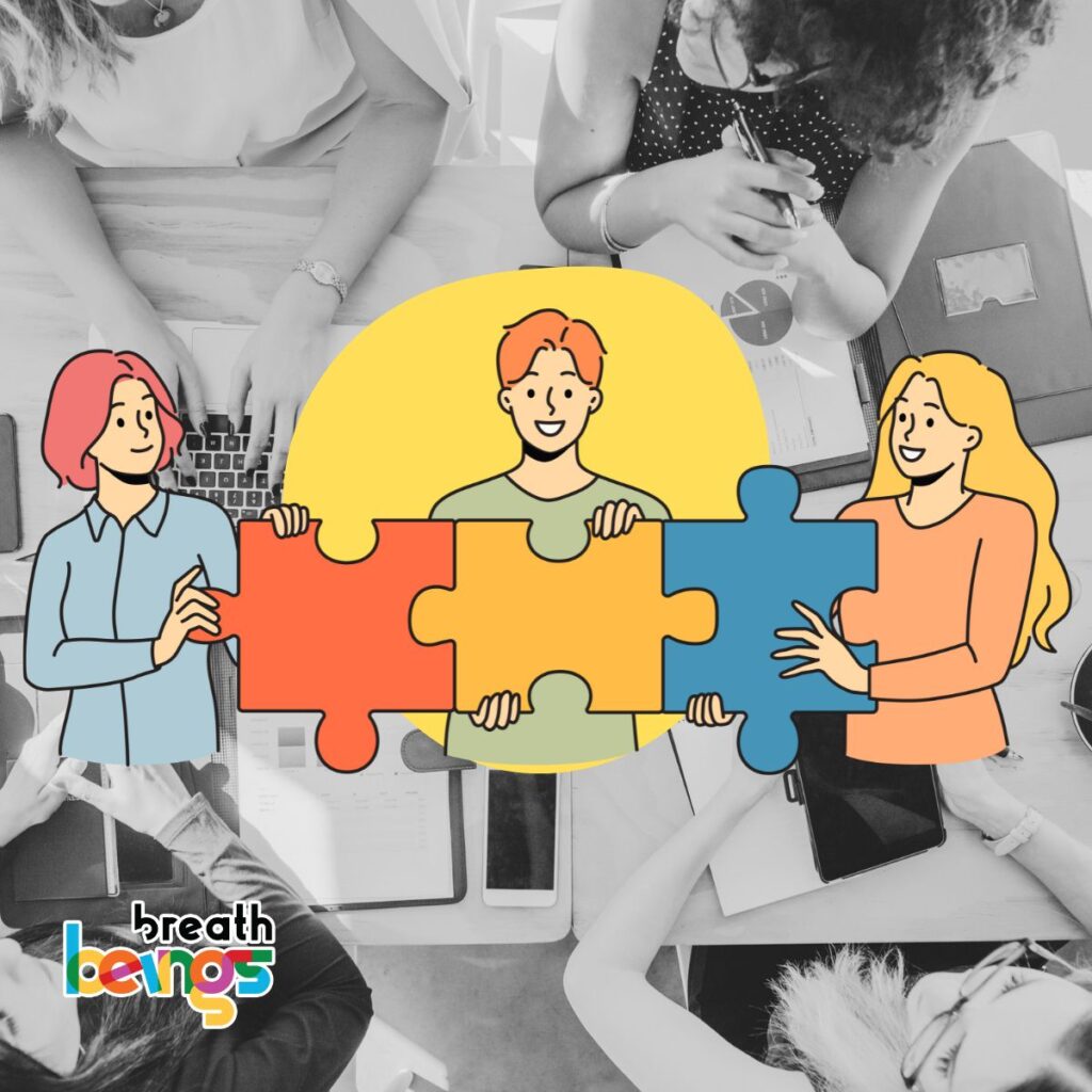 The image has a black-and-white background of a team working at a desk with laptops, tablets, and documents, overlaid with colorful cartoon illustrations. The illustrations depict three cheerful characters holding connected puzzle pieces in red, orange, yellow, and blue, symbolizing collaboration.